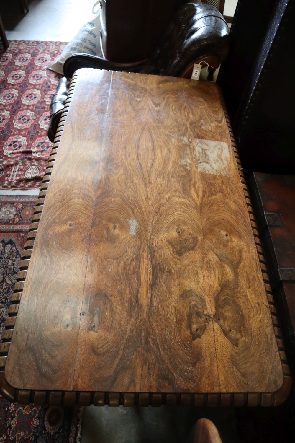 A William IV rosewood centre table, the top with rounded corners and dentil-moulded edge, on lions paw feet, width 136cm depth 70cm